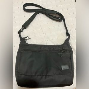 PacSafe waterproof black travel purse with safety theft lock